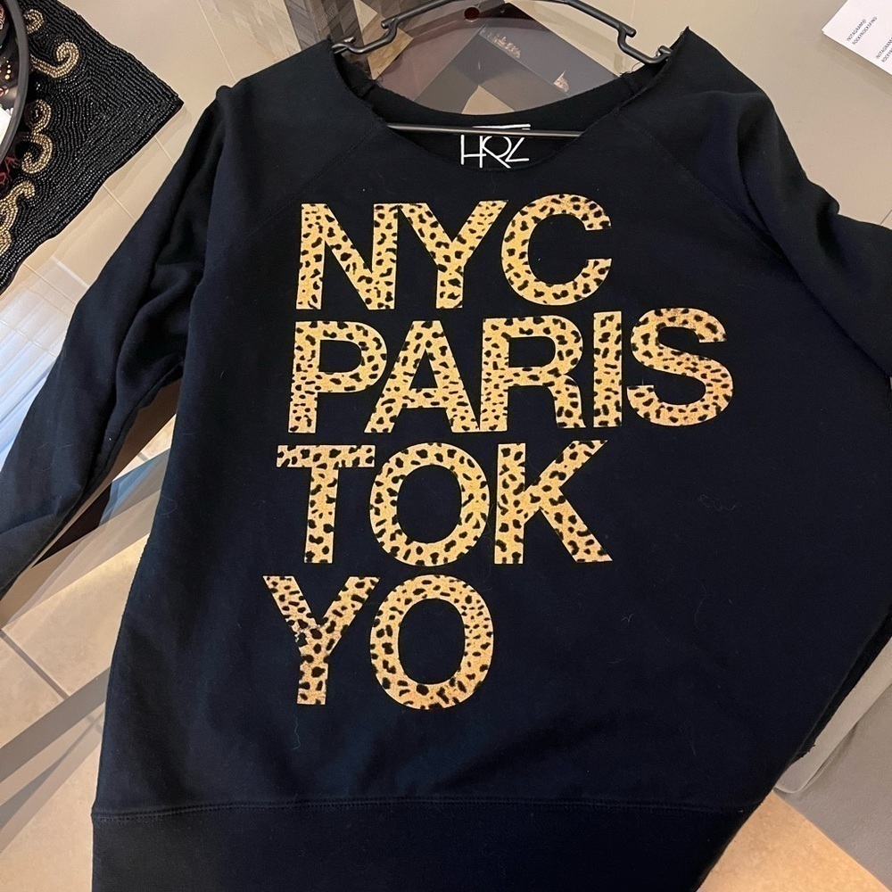 Black sweatshirt size LRG with “NYC PARIS TOKYO” front. Has a flashdance collar.